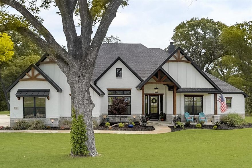 Beautiful Fully Loaded Home! Situated at the end of a cul de sac with a wooded creek in the backyard. Stunning curb appeal with stone accents, cedar beams, large front porch, privacy glass front door. Wood Floors adorn the majority of the home. Soaring Ceilings in the family room with cedar beams. Gourmet kitchen with granite counters, quartz center island, stainless apps, glass cabinets, dbl ovens, and 5 burner cooktop. Study with decorative wall molding, barn door, and fiberoptic internet. Primary Bedroom is perfect for king size furniture. Primary bath with dual sinks, walk in shower with dual heads, & freestanding tub. Additional features Foam insulation, reverse osmosis water, and so much more. You wont find a more private, serene, and peaceful backyard. The back covered patio with fireplace and built in grill is perfect for outdoor living & entertaining. This home is a MUST SEE!