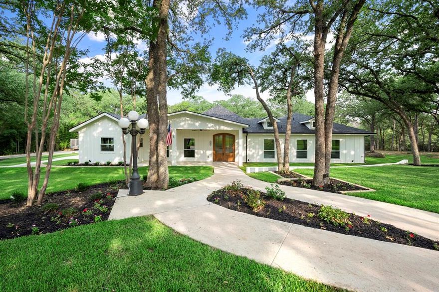 This completely remodeled home sits on 1.11 acres, offering privacy and serenity. Located on a cul-de-sac, this gem boasts 6 bedrooms, 6.5 baths, which includes a detached in-law suite, and a 4-car garage. Inside, you'll find a spacious living area, a theater room, and a large mudroom for easy organization. The master suite features a luxurious bathroom. For outdoor enthusiasts, there is space to build a sports court, access to trails leading to Grapevine Lake and a beautiful gazebo. Twin Coves Park is just a 3-minute car ride away! Modern amenities include data wiring in every room, and the kitchen is well equipped with a massive 66-inch freezer refrigerator, a 48-inch gas range with dual electric ovens and ample counter space for preparing delicious meals.. Bring the outdoors in with a 12-foot wide glass door leading to the back patio. Don't miss this 6,499 sq ft haven where privacy, luxury, and convenience meet. This home is NOT subject to any HOA. Schedule a viewing today!