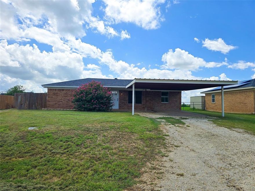 Nestled just a few miles from town, this semi-secluded home offers the perfect blend of country living with modern amenities. Inside, you'll find stylish vinyl plank flooring and sleek stainless-steel appliances that enhance the home's contemporary feel. The property boasts a spacious backyard, perfect for outdoor activities and relaxation. Additionally, there's a 25x30 workshop equipped with electricity and a 50-amp RV hookup, ideal for hobbyists or those in need of extra storage space. The two-car carport provides convenient parking. Enjoy picturesque views of the expansive open land in the back, creating a serene and inviting atmosphere. Buyers are encouraged to verify the square footage.