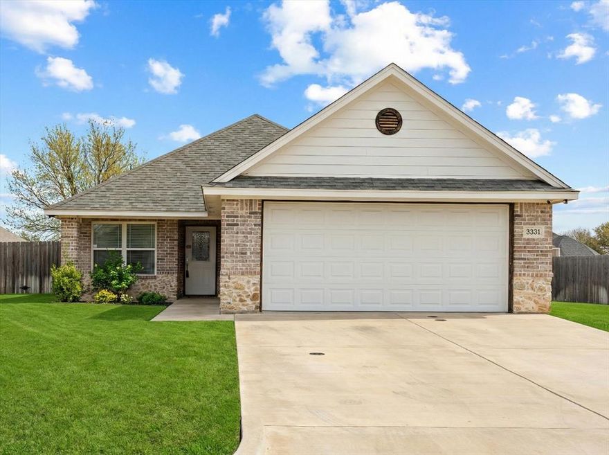 This beautifully designed 3 bedroom, 2 bathroom home with an office has a thoughtful layout and quality finishes throughout. Work from home in style with a dedicated office featuring elegant French doors, or use this space for an additional bedroom. The heart of the home features a seamless flow between the living room, dining area, and kitchen with is ideal for everyday living and entertaining. The living room centers around a cozy gas fireplace, creating warmth and ambiance year-round. The kitchen is appointed with granite countertops and stainless steel appliances. The spacious primary bedroom is a true sanctuary. The en suite bathroom impresses with a large walk-in shower, dual vanities with two sinks, and a stylish barn door that adds a touch of character. A generous walk-in closet rounds out this private retreat with all the storage you could want. Two additional bedrooms and a second full bathroom provide plenty of space for family, guests, or whatever your needs may be. The laundry room is off the garage entry with built in cabinetry, adjacent you'll find the mudroom room offering smart built-in storage to keep life organized.  Step outside to a beautifully maintained, fully fenced yard. Perfect for pets, play, or simply unwinding in your own private space. The covered patio extends your living area outdoors, making it easy to enjoy morning coffee.