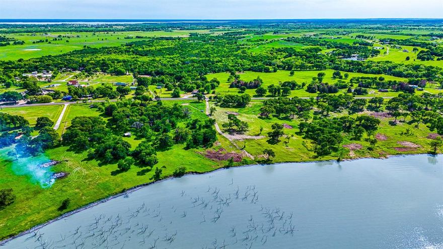Welcome to this exceptional 1.014-acre lot located in a new small subdivision within the highly desirable Mildred ISD! This beautiful property features 190 feet of shoreline along Richland Chambers Lake, offering a fantastic opportunity to build your dream home or a peaceful lakeside getaway. Utilities are conveniently available at the road, with the buyer responsible for obtaining a meter at the property.  Amenities will include a gated security front entrance, a perimeter fence for added safety, paved roads for easy access, and a convenient boat ramp for water activities. There are no time restrictions on building, allowing you the flexibility to plan your dream home at your own pace. You can choose your own builder, or you have the option to work with the developer-builder, who is available to assist you with the construction of your new home. Don’t miss out on this rare opportunity to own a stunning piece of land with breathtaking lake views. Contact us today for more information or to schedule your visit!