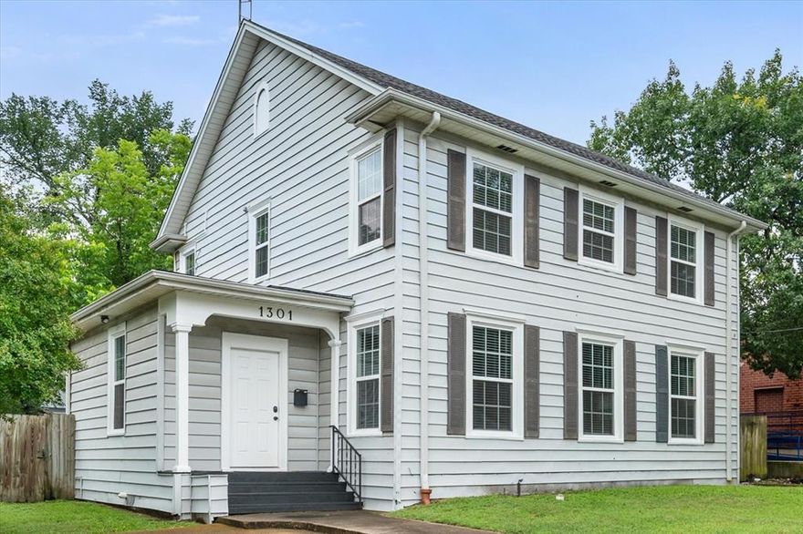 Extreme Makeover gives this home modern flair with storybook charm!  You'll enjoy the flexible floorplan with so many options to utilize the space and make it your own.  Many updates include flooring, lighting, ceiling fans and energy efficient windows throughout the home.  Abundance of natural light is so warm and inviting!  Large open den features a mock fireplace with pretty mantle and built in book nooks on each side.  There is one bedroom downstairs with a walk-in dressing room with closets, leading to the updated bathroom.  Nice stairway off the living area, lined with shiplap...leads to the upstairs four bedrooms and another updated bathroom.  Ample space for various living, dining, bedroom or office arrangements.  You can even have a home business in this General Retail Location.  Covered patio area at the side, perfect for outdoor entertaining with access to a large, shaded back yard.  Double garage located at the back of property with entry from the side road.
All information is deemed reliable and correct but should be verified by buyer and buyer's agent for accuracy.