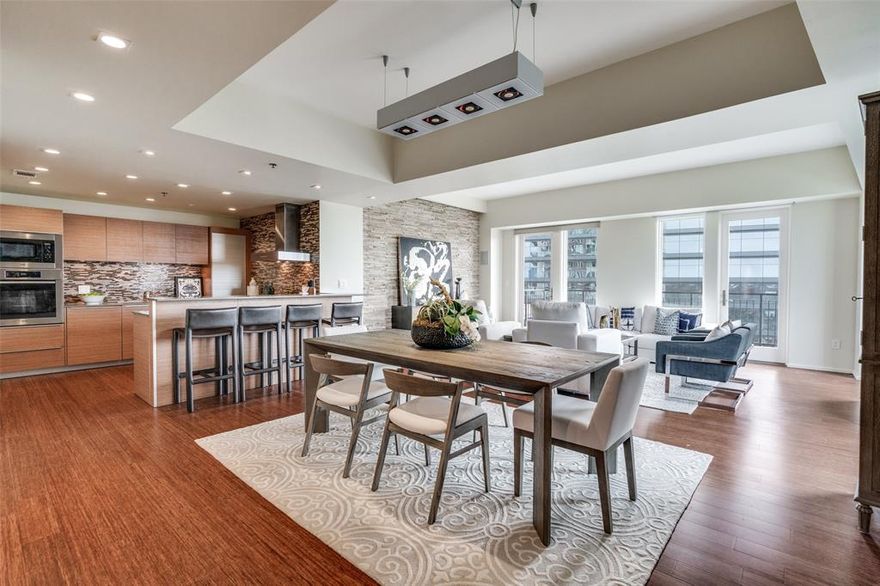 Fabulous opportunity to be in the heart of one of Dallas' most desirable neighborhoods! Ideally positioned along the coveted Katy Trail and just moments from Dallas’ premier shopping and dining destinations, this exceptional corner residence offers unparalleled walkability throughout the Knox District, bordering Highland Park. This expansive two-bedroom residence, plus a separate third room ideal for a private office, study, or gym, is wrapped in walls of windows that flood the home with natural light. Two private balconies showcase sweeping views of Downtown Dallas, Highland Park, the Katy Trail, and SMU—creating the perfect backdrop for morning coffee or sunset evenings overlooking the skyline. The chef’s kitchen seamlessly blends elegance and functionality, featuring custom cabinetry, striking quartzite countertops with a matching backsplash, and premium appliances, including a built-in Miele coffee maker and wine refrigerator. The spacious primary suite offers a tranquil retreat with its own private balcony and generous custom closets. An oversized guest suite includes a walk-in closet and a spa-inspired bath, providing comfort and privacy for visitors. Thoughtful upgrades elevate this home even further, including a recently installed high-rise leak detection system, a whole-home water shut-off system, and an electric vehicle charging connection in the garage—offering modern convenience and peace of mind. Residents can enjoy an impressive array of resort-style amenities, including a newly renovated pool, outdoor kitchen, gas fire pit, 24-hour concierge, fitness center, dog run and private storage. This is refined urban living at its finest—where luxury, location, and lifestyle converge. Home conveys with two assigned parking spots. The Travis location is right at the Knox Henderson Intersection with direct access to Katy Trail sitting 17 stories high with 63 residences.