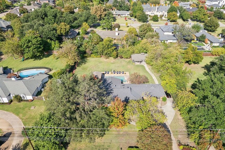 This exceptional estate on almost an acre offers a rare opportunity to own a piece of Preston Hollow as the foundation for a visionary new build among neighboring multimillion-dollar homes in the Strait Lane area.
Or....Use this exceptional opportunity to update.  Experience the allure of this iconic Charles Dilbeck residence, a rare Preston Hollow treasure that marries architectural heritage with resort-style living. Perfectly positioned on nearly an acre, this 1951 mid-century modern showcases Dilbeck's signature vaulted ceilings and hand-carved beams, complemented by large, open living spaces and oversized windows that invite abundant natural light.
Entertain effortlessly in a recently updated, chef-inspired kitchen with state-of-the-art appliances and a spacious center island that flows seamlessly into a relaxed den overlooking the spectacular backyard and sparkling pool. The formal dining room offers panoramic garden views, while the luxurious primary suite serves as a tranquil retreat, complete with a spa-caliber bath, dual vanities, a soaking tub, and a generous walk-in closet. 
Step outside to resort-level amenities: a pristine pool, covered patios for year-round alfresco dining, a built-in outdoor kitchen, and a sprawling yard designed for both grand entertaining and quiet relaxation. A versatile detached workshop offers excellent potential for conversion into a guest cottage or private office. Prime location close to Ursuline, ESD and several private schools. Minutes from top restaurants, shopping and Love Field.