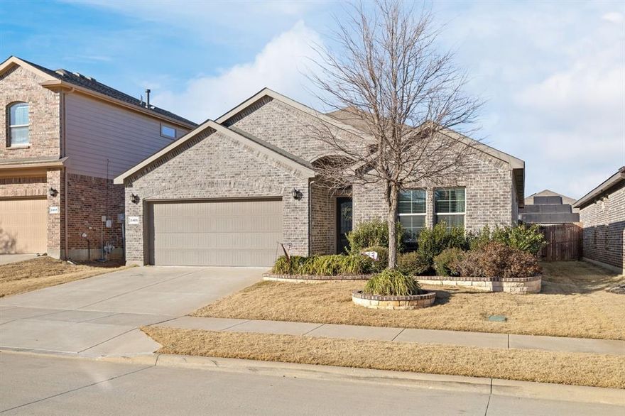 Welcome to this beautifully maintained home completed in 2019, offering 2,109 square feet of thoughtfully designed living space in the highly sought-after Oak Creek Trails community. This 3-bedroom, 2-bath stunner sits just off Highway 114 in North Fort Worth, providing easy access to Northwest High School, Texas Motor Speedway, Tanger Outlets, Buc-ee's, and the Golf Club at Champions Circle—everything you need is right at your fingertips.

Inside, you'll love the open-concept floorplan that's perfect for modern living and entertaining. The kitchen features a large island with granite countertops, a gas cooktop, and an on-trend backsplash that was updated in 2023. Gorgeous wood-look tile flooring flows throughout the main living and dining areas, delivering both style and durability for everyday life.

The primary suite is a true showstopper—extra spacious with plenty of room to add a sitting area or home office setup. The smart split floorplan places two secondary bedrooms on a separate hallway for maximum privacy, while a versatile bonus room at the front of the home can serve as an office, playroom, or guest suite. Just off the entrance, you'll find a convenient mud bench and an expansive walk-in closet, giving you all the storage options you need.

Outside, the covered patio is ready for Texas game days, family cookouts, and outdoor entertaining. Complete with a TV mount and plenty of space for your patio furniture and grill, this is where memories are made on those perfect weather days.

With its prime location near top-rated schools, major highways, shopping, and entertainment, this home delivers the complete North Fort Worth lifestyle package. Don't miss your chance to make it yours.