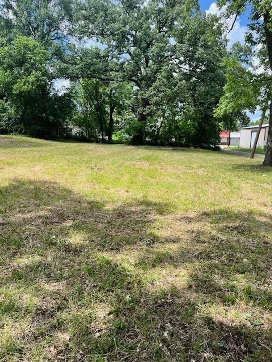Vacant city lot spanning approximately 0.203 acres (8,843?sq?ft) at 1300 W?Kaufman St, Paris, TX?75460. Lot is cleared and ready for development. Public water and sewer utilities available at the street. Located within Paris ISD (zoned to Aiken Elementary, Paris High). According to MLS records, the zoning is listed as “unzone”, but buyers are advised to verify permitted uses directly with the City of Paris.