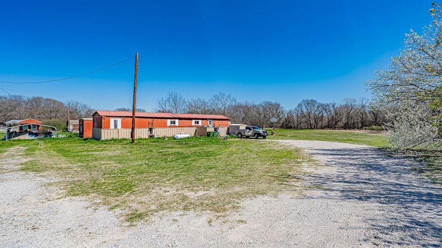 Welcome to Paradise, Texas—where the name truly reflects the setting. This scenic 5-acre, tree-covered property offers a unique opportunity for both investors and future homeowners. The land is lush and green year-round and features two well-maintained mobile homes, both currently producing income.

The first home offers 3 bedrooms and 1 bathroom, while the second features 2 bedrooms and 1 bathroom. Both homes have new roofs and are separately metered for electricity, which is paid by the tenants. City water services the property, with usage handled between the tenants, and there are two separate septic systems in place.

With no zoning restrictions, this property offers flexibility—continue operating as a rental investment, build a new home, or explore other permitted uses. A county restriction allows one home per 2.5 acres, providing additional development potential.

The property currently generates $1,660 in gross monthly rental income, with both tenants on month-to-month leases, offering flexibility for a new owner.

Owner financing is available with a substantial down payment at 5% interest for 20 years, making this an attractive opportunity to own acreage in a desirable rural setting.