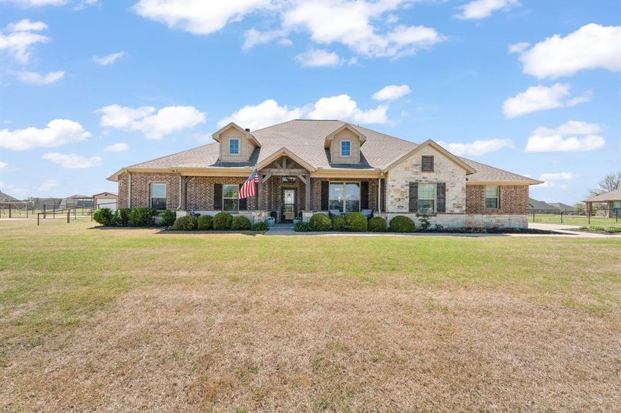 Welcome to 7925 Grassland Trail in Godley, Texas—where style, space, and functionality come together on a beautiful oversized lot in highly sought-after Godley ISD.
From the moment you arrive, you’ll love the stunning curb appeal with stone and brick exterior, inviting front porch, and wide-open Texas skies. Step inside to a warm and welcoming open-concept floorplan featuring rich wood flooring, decorative wood beam accents, and a gorgeous stone fireplace that anchors the living space.
The kitchen is truly the heart of the home, offering custom cabinetry, granite countertops, stainless steel appliances, double ovens, and an oversized island—perfect for gathering, entertaining, and everyday living. The seamless flow into the dining and living areas makes this home ideal for hosting. It has 2 living areas, formal dining, office and so many custom features that make this property special
The spacious primary suite is a private retreat with plenty of room to unwind, featuring a spa-like bathroom with dual sinks, soaking tub, separate walk-in shower, and a large walk-in closet.
Now let’s talk about the backyard… this is where the magic happens!
Step outside to your very own outdoor oasis featuring a beautiful in-ground pool with water feature, expansive deck space, and a covered patio—perfect for summer days, evening gatherings, and making memories year-round.  Plus a separate guest house that features a bedroom , bath and additional 2 car garage. This great space is great for guests or a poolside cabana or game room . 
All of this with a peaceful country feel while still being just minutes from the Chisholm Trail Parkway for an easy commute to Fort Worth.
This one truly checks all the boxes—space, style, and a backyard you’ll never want to leave.