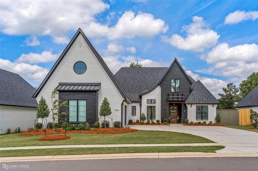 Your next dream home is here! Located in the golf community of Southern Trace, this property features a keen attention to design from the moment you arrive. The professional landscaping and stunning white brick with black accents give a great first impression. As you step inside, you're greeted with custom light fixtures and wood-look tile throughout the main living space. With a high coffered ceiling, custom built-ins, and a cozy fireplace, the living space is sure to be a favorite place to gather. The gourmet kitchen boasts custom cabinets, a huge center island, modern fixtures, and butler's pantry. Entertaining will be a breeze, whether you host guests in the separate formal dining room, or outside on the expansive covered patio complete with outdoor kitchen and fireplace. Relax after a long day in the remote primary suite, featuring a vaulted ceiling with beam detail and a spa-like ensuite bath boasting a luxurious soaking tub, custom tiled shower, and dual vanities. Three additional bedrooms share two full baths downstairs offering plenty of space for family or guests. Upstairs, the bonus room gives you the flexibility to meet your unique needs, whether you use it as a media space, game room, or 5th bedroom. A dedicated office and full bath complete the second floor. Additionally, there is both a 55-gal water heater and tankless water heater so you're never without a hot shower! Community amenities include a guarded entrance, golf course, club house, pool, and tennis courts. Don't wait, schedule your private tour today and fall in love with this absolute masterpiece!