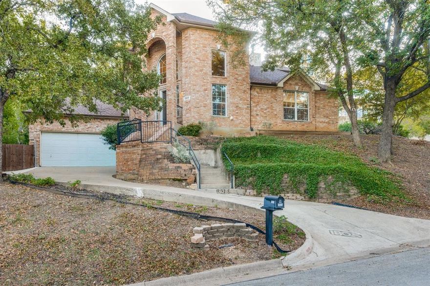 Welcome to the rolling hills of beautiful Arlington.  This beauty is situated overlooking the gorgeous view of Enchanted Oaks Subdivision.  This home features an oversized living dining combination with a fireplace in between OR a HUGE family area that is adjacent to the wonderful main kitchen, with loads of cabinets, a GREAT island for prep and a serving bar adjacent to the dining area; but don't miss the mini kitchen combination in the laundry with its own gas range and stove and separate sink AS WELL AS a utility sink.  This is every mom's laundry dream! The primary bedroom is located on the first floor with a HUGE primary bath with dual sinks, extended vanity area and a bidet, with separate shower and jetted tub.  Be sure to see  the linen closet and the ENORMOUS walk in closet.  The upstairs has either 3 bedrooms or 2 bedrooms with a study.  One bedroom, with a walk in closet, has French Doors, could easily be used as a study.  A Jack and Jill bath is ideal for getting the kiddos ready for school with separate sinks and a  shower!