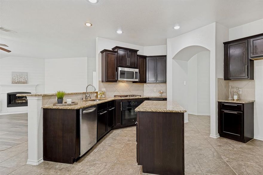 PRICE REDUCED FOR THIS SPACIOUS NORTH FACING ONE STORY HOME! This home has been very well maintained and has a thoughtfully designed floor plan which provides an open concept living area with plenty of windows for abundant natural light! This one is a real gem!  NO CARPET in the home, only wood type flooring and tile for easy care and less allergies! You'll find an oversized living area, perfect for entertaining large gatherings! A corner gas fireplace adds warmth and charm. Large open kitchen with island, tons of 42 inch cabinetry and granite counter space, stainless steel appliances, walk in pantry, breakfast bar, filtered water, and a dining area which works for any size crowd.  The backyard has an extended concrete patio, a free standing pergola for shade, and lots of grassy area for play.  The side yard is PERFECT FOR A LARGE GARDEN area and gets plenty of sunshine. ALL INTERIOR WALLS AND TRIM HAVE FRESH PAINT with popular Alabaster white paint. The Primary bedroom offers a generous layout with a walk in closet and tastefully appointed ensuite bath with double sinks, garden tub, and separate shower.  Nice wide entry area leads to additional bedrooms which are versatile, well-sized, and perfect for various uses, be it a guest room, a home office or a private retreat.  Low maintenance WHOLE HOUSE WATER FILTRATION SYSTEM! Valor Pointe is zoned for PROSPER ISD, and features great amenities including well maintained parks, and a fabulous water park with slides and lifeguards. McKinney is one of the most sought-after cities in North Texas! This friendly neighborhood offers easy access to schools, shopping and dining! Make this gem your next home and enjoy a perfect blend of comfort, style and convenience.