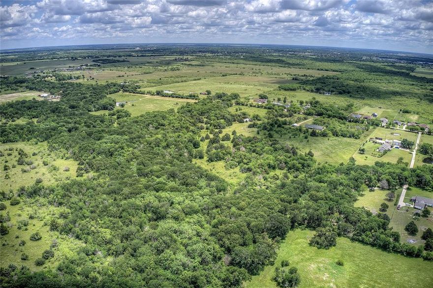 Beautiful Place to Build a Dream Home, build a Ranch with rolling terrain, use Bungalow Home as a home or while building, winding creek and partly wooded. Over 1600 feet of road frontage, wide, wooded area behind with several ponds. Perfect location for privacy.  Outside of City Limits and Presently in Wildlife for Exemption. Close to Terrell, Rockwall, Forney and easy access to major freeways yet, the Country Feel. Peaceful, rural oasis just outside of the city. Ponds and some wooded areas offer both tranquility and the chance to enjoy nature while still close to urban amenities.  Bring the animals. Part of this land is in Flood Plain. Details of Bungalow can be seen on MLS# 20930601, bungalow included with the full parcel sold as one. Includes 1 water meter and electric presently to home.