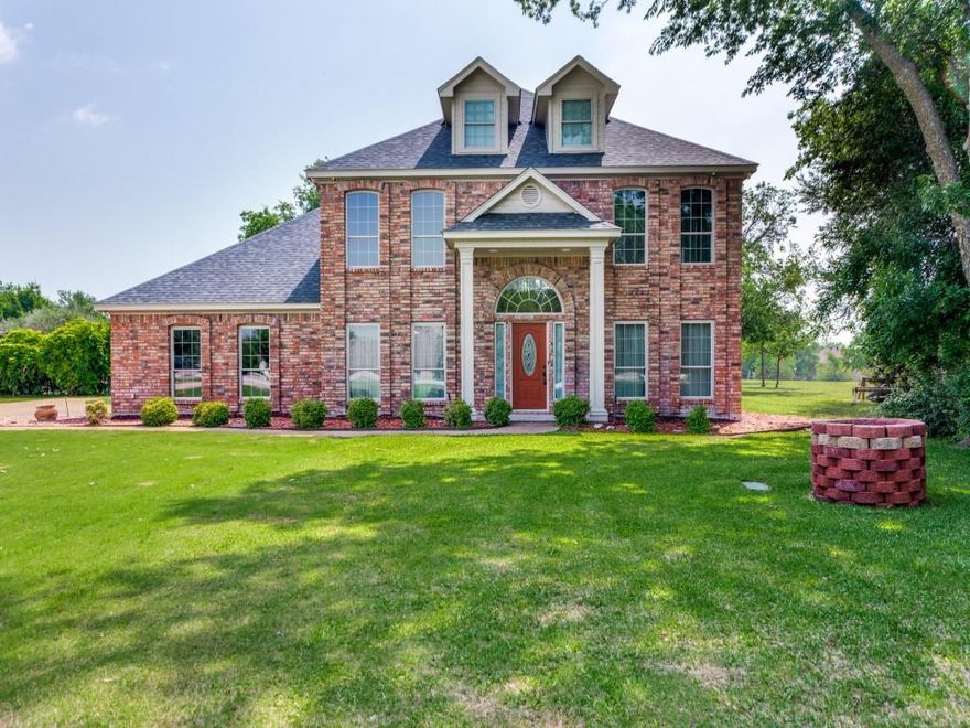 Peaceful country living just minutes from town! This beautifully crafted custom home sits on a full acre in the highly sought-after Tiger Trail area—truly one of the best-kept secrets around. Enjoy the freedom of no mandatory HOA, no city taxes, and walking distance to Benbrook Lake. Surrounded by nature, you’ll love relaxing evenings watching deer, birds, and local wildlife right from your own backyard. This well-maintained home features updated vinyl windows for energy efficiency, abundant insulation, a roof installed in 2020, and a full yard sprinkler system. Inside, the open floor plan is perfect for both everyday living and entertaining. The sunny kitchen offers a wraparound breakfast bar, stainless steel appliances, and durable hard-surface countertops. The spacious living area is anchored by a cozy wood-burning fireplace and custom built in bookcases. The downstairs primary suite is a true retreat, complete with an exquisite bath featuring a garden tub, separate shower, dual sinks, hard-surface counters, and a generous walk-in closet. Experience the perfect blend of comfort, privacy, and convenience—this is country living at its finest! Seller offering $5000 to buyer for closing cost credit or interest rate buy down. First American Home Warranty included.