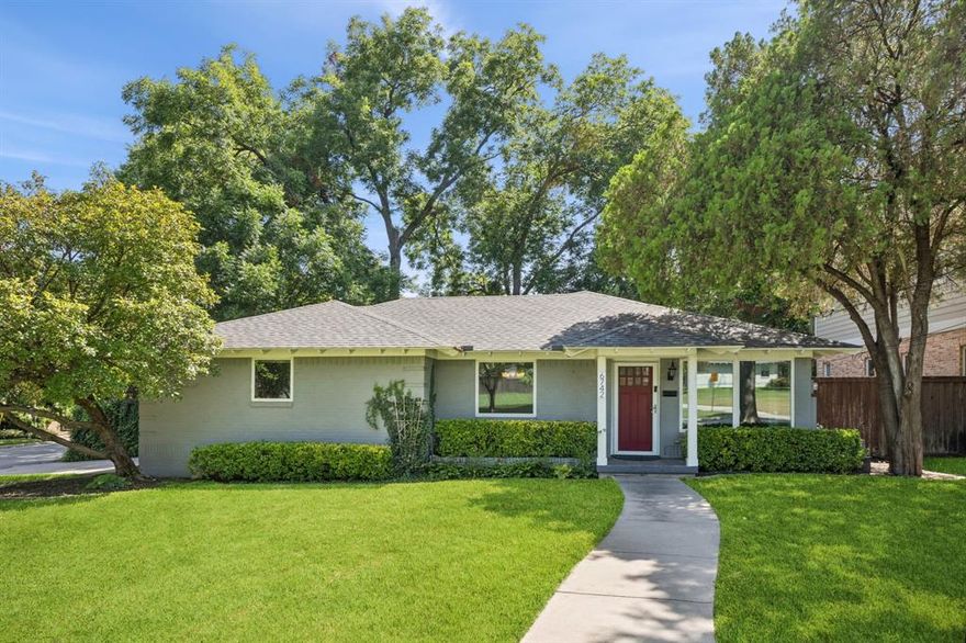 Exceptional location situated on a highly sought after waterfront, creek lot in the heart of Lakewood, home features updated KITCHEN, stainless appliances, granite counters, horizontal staggered tile backsplash, 4-burner gas cooktop, window above dual stainless sink, display cabinets w frosted glass, shelved pantry, wood floors, BREAKFAST w built-in banquette seating, storage drawers, custom shelving, decorative lighting, a FORMAL DINING with decorative chandelier, and wood floors adjacent to light-filled oversized LIVING at front of home with wood floors and multiple windows allowing abundance of natural light. PRIMARY ensuite at rear of home w decorative ceiling fan, wood floors, marble tile, floating vanity, dual sinks, walk-in tile surround shower w glass enclosure, and designer tile backsplash. Secondary BEDROOM w half BATH, walk-in closet and wood floors. Add'l BEDROOM suitable for office or flex room w space-saving pocket doors, shelved walk-in closet and wood floors. Full BATH in main hallway features tile bathtub, floating vanity, decorative lighting and full size Washer-Dryer area. Notable upgrades include windows replaced throughout, exterior doors w integrated adjustable mini-blinds, recessed lighting, recently painted interior, large backyard, sprinkler system, security system, side-entry garage, rear outdoor PATIO for entertaining, and wood dock at water's edge for launching boat, fishing or relaxing among towering trees in serene setting.  Located just minutes from SoPac Recreational Hike & Bike Trail, Lakewood Park, White Rock Lake, Dallas Arboretum & Botanical Gardens, area shopping centers, dining, and convenient to downtown Dallas.  A rare opportunity to invest in one of Lakewood's desirable neighborhoods!