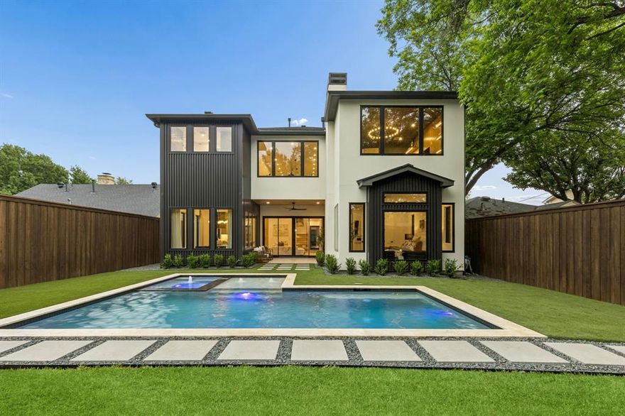 A statement in contemporary design, this 2026 new construction architectural showpiece blends refined finishes, thoughtful functionality, and exceptional craftsmanship in one of Dallas’ most desirable locations. This stunning 5-bedroom residence offers 5 full baths and 2 half baths, with every bedroom featuring its own ensuite bath for comfort and privacy throughout.
A striking custom steel and glass front entry door sets the tone, opening to interiors defined by soaring ceilings, abundant natural light, wide-plank white oak flooring, and designer-selected finishes throughout. The main level includes a private office, spacious laundry room with dog wash, mudroom, and an extraordinary primary suite complete with a spa-inspired bath and oversized custom walk-in closet.
At the heart of the home, the dramatic living room is anchored by a floor-to-ceiling fireplace, custom built-ins, and 20-foot ceilings that create a grand yet inviting atmosphere. The chef’s kitchen is appointed with double ovens, built-in refrigerator, quartz countertops, an oversized waterfall island, abundant cabinetry, and a dedicated scullery-prep kitchen. A walk-in pantry and beverage center further elevate the space.
Upstairs, four additional ensuite bedrooms include a secondary primary suite, ideal for guests or multigenerational living. A spacious loft, game room with fireplace, media room, and additional half bath provide flexibility for entertaining or relaxation.
Expansive sliding doors create seamless indoor-outdoor flow to the covered patio and resort-style backyard, complete with a pool and spa. Additional highlights include custom millwork, Andersen windows, an insulated two-car garage with epoxy floors, and professionally designed landscaping with striking curb appeal.
Perfectly positioned in the heart of Dallas, this exceptional home offers quick access to premier dining, shopping, Love Field Airport, and the best of city living.