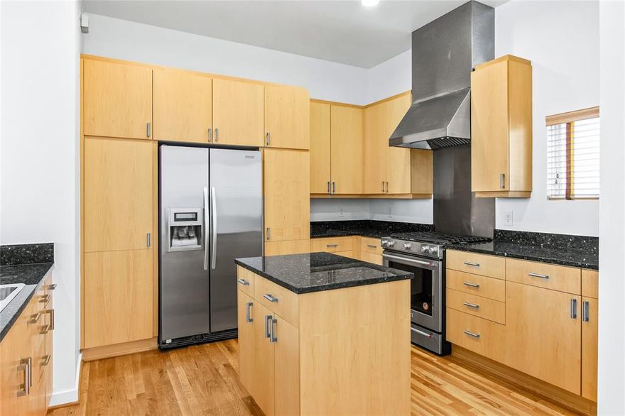 This contemporary townhome blends soaring architecture with true lock-and-leave convenience, just seconds from the Katy Trail, Knox-Henderson, and West Village. Dramatic 22-foot ceilings, expansive floor-to-ceiling windows, and incredible natural light create a bright, airy living experience throughout. The second-floor living and kitchen level is designed for entertaining, featuring granite counters, an island for gathering, stainless steel appliances, and a built-in wine refrigerator. With bedrooms on separate floors, the layout offers exceptional privacy. Each suite includes its own ensuite bath and walk-in closet, while the primary retreat features an upgraded closet system and a spa-inspired bathroom with a separate shower and soaking tub. Additional highlights include a private 2-car garage, a second-floor balcony perfect for morning coffee or sunset views, and hardwood floors throughout. Located within The Vitano Townhomes and offering direct access to the Katy Trail, this home delivers an effortless lock-and-leave lifestyle with some of Dallas’ best dining, shopping, and cafés just around the corner.