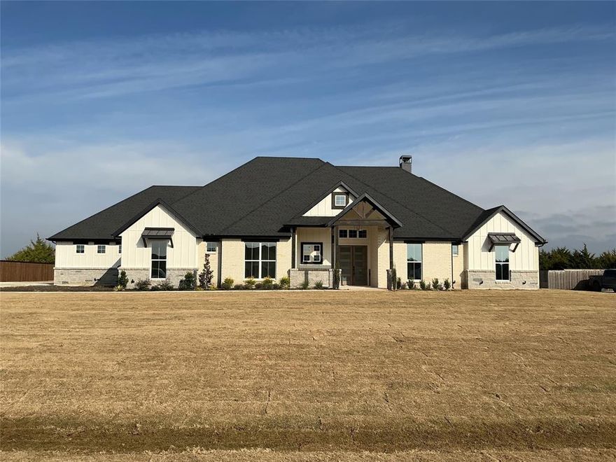 OPEN HOUSE SAT 2PM-5PM & SUN 1PM-3PM. One-of-a-kind in Ellis County, this custom home by long-time builder Maxwell Custom Homes is nestled on a heavily treed, acre-plus lot in North Waxahachie. Located in a neighborhood known for quality builders and spacious one-acre homesites, this property offers the perfect blend of privacy, luxury, and convenience to town. Step inside to a stunning living room anchored by 12-foot ceilings with decorative beams and a gas fireplace, creating a warm and elevated gathering space. The heart of the home is the chef-inspired kitchen, featuring custom cabinets to the ceiling, a large island with decorative pendant lighting, and wet bar complete with wine fridge and mini fridge - ideal for entertaining. The thoughtful floor plan includes 4 bedrooms, 3.5 bathrooms, a dedicated study, and a game room, giving everyone space to spread out. The spa-like primary suite feels like a retreat, with a large walk-in shower with rain head, soaking tub, and a huge walk-in closet designed for serious storage. Secondary bedrooms are perfectly set up for guests or family with ensuite bathrooms. Outdoor living takes center stage with an expansive covered patio, a second gas fireplace, and stub outs for an optional outdoor kitchen - the perfect spot to unwind, host friends, or simply enjoy the wooded backdrop and peaceful setting. 250 gallon buried propane tank is also included. If you’ve been looking for a luxury custom home on an acre-plus lot with trees, privacy, and a highly functional floor plan, this one checks every box. Schedule your showing today!