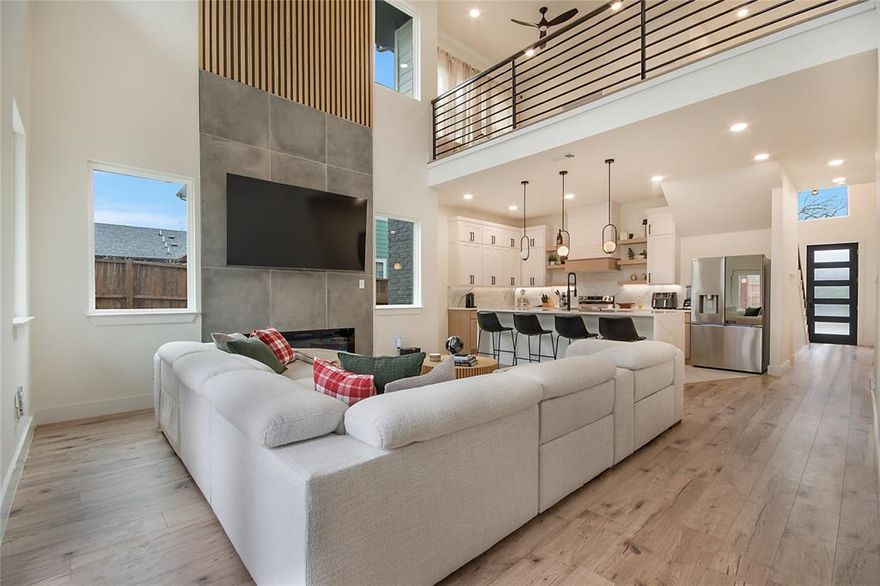 Stunning modern home featuring 10-foot ceilings throughout and a dramatic 25-foot foyer filled with natural light. The open-concept layout showcases a chef’s kitchen with quartz countertops, stainless steel appliances, and custom underlit cabinetry. Upstairs offers a second living area with an open-to-below design and access to a second-floor balcony overlooking the backyard—ideal for entertaining. Enjoy a low-maintenance turfed yard with a new pergola, plus the privacy and security of a gated home. Move-in ready and designed for modern living.