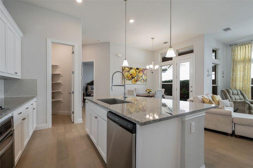 LIKE NEW 2021 Single-Story Living in Prime Argyle ISD! Why wait for new construction when this beautifully maintained, modern home in Waterbrook is ready for immediate move-in? This location is a true lifestyle choice, offering immediate access to the community's extensive walking trails, peaceful ponds, and green spaces. Featuring an elegant brick and stone façade and a coveted alley-entry garage, this home offers superb curb appeal and functionality.
The Perfect Blend of Comfort & Style (1,800+ SF): Step inside the bright, open floorplan, showcasing light hardwood flooring and designer neutral tones throughout. Enjoy the timeless elegance and premium privacy provided by custom plantation shutters on every bedroom window. The spacious family room is anchored by a cozy gas fireplace, perfect for gathering on a cold night.
Chef's Kitchen & Seamless Entertaining: The thoughtfully designed kitchen boasts a large center island, built-in cabinetry, stainless steel appliances, and a dedicated pantry. It flows seamlessly into the eat-in dining area, making hosting a breeze. 
The serene primary suite is tucked away for privacy, complete with an ensuite bath and walk-in closet. Two additional secondary bedrooms with walk-in closets are located at the front of the home, served by a centrally located full bath.
Outdoor Oasis & Lifestyle: Enjoy Texas evenings on your covered patio, perfect for grilling and relaxing in your private, wood-fenced backyard (sprinkler system included). Take advantage of the many walking trails just steps from your door and the nearby community pond views.
Location & Peace of Mind: Nestled on a quiet interior lot in the desirable Waterbrook community, this home is zoned for the top-rated Argyle ISD. With easy access to amenities and a low-maintenance, fully fenced, and sprinklered yard, this is the perfect place to call home. Schedule your private showing today and explore the Waterbrook trails!