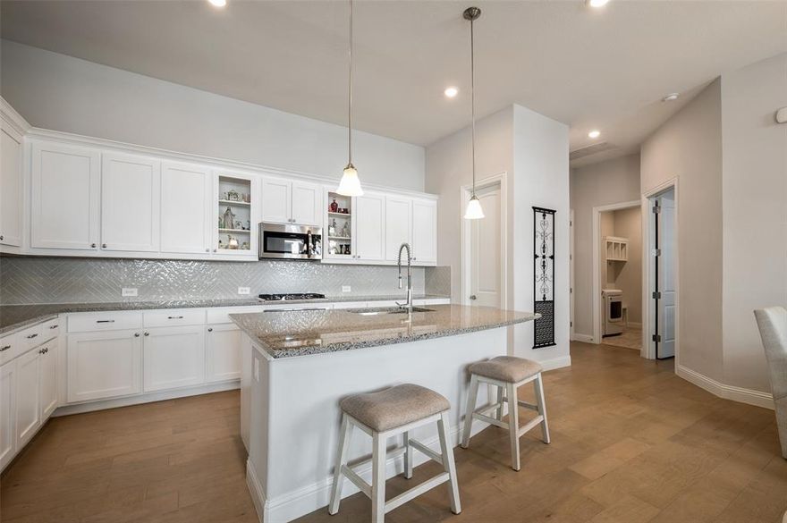 LIKE NEW 2021 Single-Story Living in Prime Argyle ISD! Why wait for new construction when this beautifully maintained, modern home in Waterbrook is ready for immediate move-in? This location is a true lifestyle choice, offering immediate access to the community's extensive walking trails, peaceful ponds, and green spaces. Featuring an elegant brick and stone façade and a coveted alley-entry garage, this home offers superb curb appeal and functionality.
The Perfect Blend of Comfort & Style (1,800+ SF): Step inside the bright, open floorplan, showcasing light hardwood flooring and designer neutral tones throughout. Enjoy the timeless elegance and premium privacy provided by custom plantation shutters on every bedroom window. The spacious family room is anchored by a cozy gas fireplace, perfect for gathering on a cold night.
Chef's Kitchen & Seamless Entertaining: The thoughtfully designed kitchen boasts a large center island, built-in cabinetry, stainless steel appliances, and a dedicated pantry. It flows seamlessly into the eat-in dining area, making hosting a breeze. 
The serene primary suite is tucked away for privacy, complete with an ensuite bath and walk-in closet. Two additional secondary bedrooms with walk-in closets are located at the front of the home, served by a centrally located full bath.
Outdoor Oasis & Lifestyle: Enjoy Texas evenings on your covered patio, perfect for grilling and relaxing in your private, wood-fenced backyard (sprinkler system included). Take advantage of the many walking trails just steps from your door and the nearby community pond views.
Location & Peace of Mind: Nestled on a quiet interior lot in the desirable Waterbrook community, this home is zoned for the top-rated Argyle ISD. With easy access to amenities and a low-maintenance, fully fenced, and sprinklered yard, this is the perfect place to call home. Schedule your private showing today and explore the Waterbrook trails!