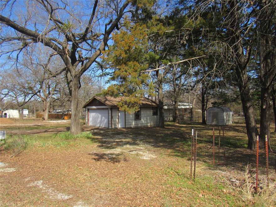 Amazing 6 lots for sale - looking for a place for a new home?  Manufactured home, mobile home, rv spot or barndo?   Great area of Sherwood Shores on beautiful Lake Texoma.   Water meter in place, electrical connected and septic on site from prior home, lot has been cleared of debris and small trees leaving massive mature trees for shade and your enjoyment.   Build a great pad and cover for your RV for summertime fun and relaxation or build your home a golf cart ride to the water's edge!   This is an estate property, nice barndos and homes on both sides and across the street.   If you are looking for a place to make your own, you may want to drive up and take a look.  Seller will divide into 2 tracts as the north 4 and the south 2 lots are platted separately.  2 driveways already place, and 4 culverts, 3 concrete pads and a great little garage shop on site, just waiting for you!