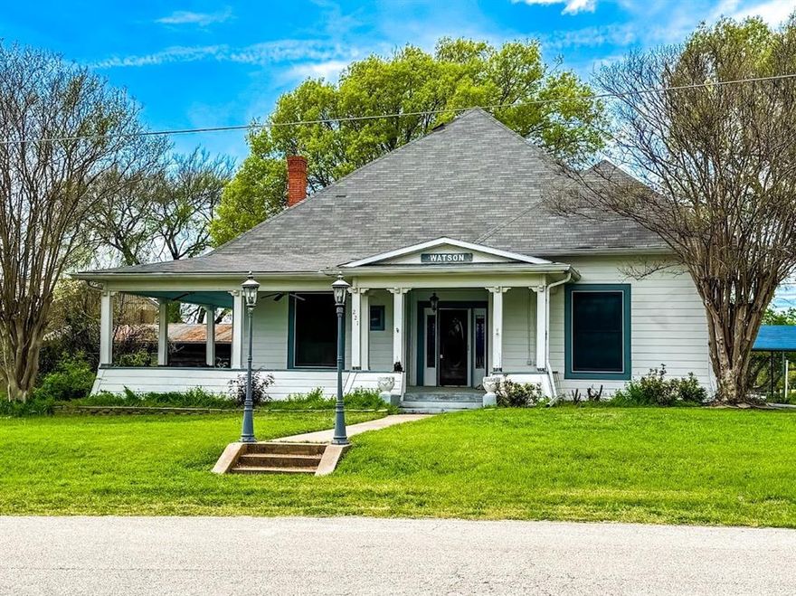 Welcome to a timeless gem situated just minutes from the courthouse square. Built in 1907, this single-story 3 bedroom, 2 bath home offers exquisite of historical features. The elegant living room, featuring polished hardwood floors & 11 ft ceilings is anchored by a classic white fireplace. Natural light floods the room through tall windows. The unique indoor heated swimming pool is set within a rustic frame of exposed wooden beams, making it a welcoming retreat.  The vintage-inspired bathroom showcases a clawfoot bathtub & a harmonious blend of white & blue mosaic tiles. The kitchen stands out with its natural wood cabinetry, reaching from floor to ceiling. Rich architectural details like intricate crown moldings & two fireplaces add charm &  warmth. Stained-glass pendant lighting & windows throughout adds a touch of color. Step outside to the covered porch, ideal for relaxation & social gatherings. Embrace the opportunity to own a piece of history where every corner tells a story.