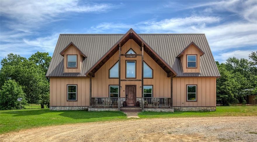 Incredible opportunity to own this unique offering just minutes from downtown SS, schools and I-30. A GLAMPING TENT unlike any you have seen, 3 RV spots and then follow the winding drive back to this custom luxury style cabin home nestled on 74 acres of Ag Exempt picturesque rolling pasture land and discover this stunning 4-bedroom, 4-bath that offers a perfect blend of fun and nature. Step inside the expansive interior of soaring wooden ceilings that add warmth and character, complemented by stained concrete and hardwood floors throughout. The centerpiece of the living room is a striking gas log stone-hearth fireplace, plus three levels of windows on the soaring front wall. The chef's kitchen is a dream with a professional-grade gas range, built-in refrigerator, and ample space for both meal prep and entertaining.  A huge island and raw-edge granite provides breakfast seating, and there are TWO walk-in pantries! Primary suite is a true retreat, with a beautifully appointed soaking tub, tiled walk in shower, two granite-topped vanities, and WIC.  2nd BR on the main floor with hall bath, and 2 BR upstairs, both with dual closets and ensuite baths.  The large gameroom space in between opens onto a balcony with a hanging bed! Enjoy outdoor living on the large covered front and back porches, or take a dip in the sparkling pool while enjoying hilltop pasture views. Spend time around the firepit, large storage building for hobby needs and sweeping pasture views, plus a SOLAR ARRAY for electric use.  Everyone will delight in the creekside glamping tent with outdoor shower and firepit.  The land is equally impressive, featuring two serene ponds and a meandering creek, offering endless opportunities for outdoor recreation, plus it backs up to Century Lake and the City of SS woodland area. Interested in hosting Weddings, Retreats or AirBNB income? This property has 2 years of history for those possibilities. Future development and more. 90 mi to DFW, 20 mi to many lakes!