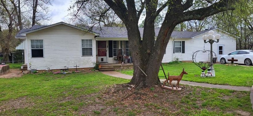 6 acres with woods and open areas. Country home over 1800 square feet having 2 bedrooms one bath, den, living room, kitchen, sunroom and more. Needs lot of ATTENTION. Many outbuilding including work shop, barns and storm shelter. Circle driveway. Property will not go FHA or VA. (No appliances stay) they belong to the tenants. MORE PICTURES COMING SOON