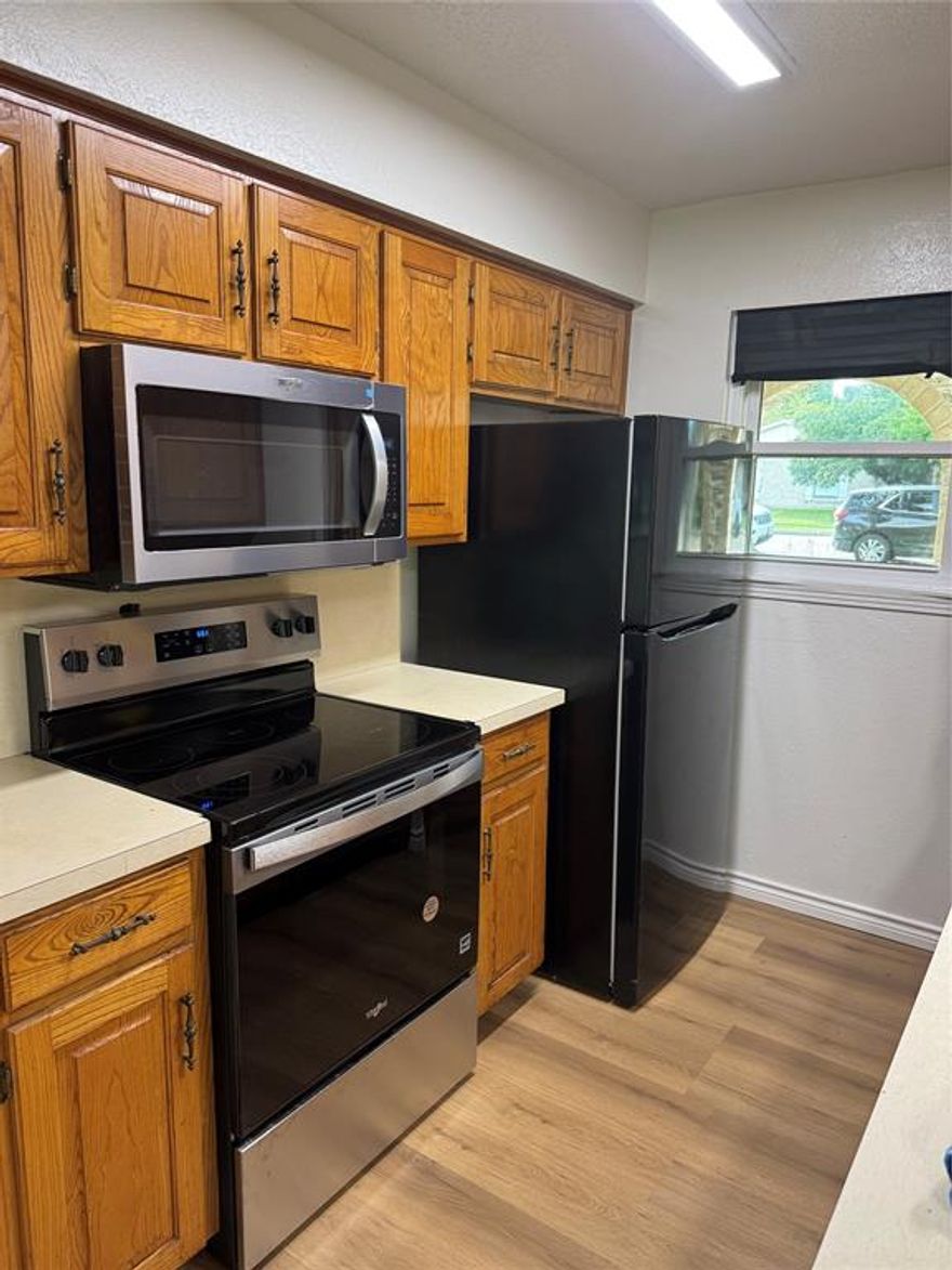 This meticulously updated with a move in ready mindset. Every interior painting need has been completed to all surfaces including new door hardware, plumbing faucets and drains, new kitchen sink with faucet. New vinyl energy efficient sliding patio door and all windows, 12 year luxury vinyl plank flooring for every room. New  dishwasher, microwave and free standing electric range. New light fixtures in every room with remote control drapes in the living room.