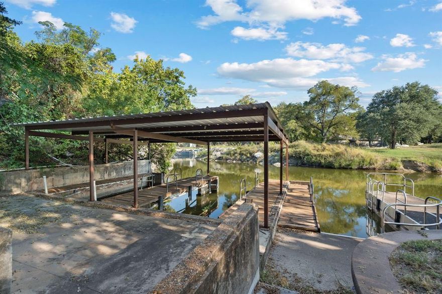 Welcome to your dream waterfront retreat on Lake Granbury! This stunning 3-bed, 2.5-bath home offers the perfect blend of modern upgrades, natural beauty, & peaceful privacy. Nestled on over an acre & surrounded by more than 65 mature cedar trees, the property has the feel of a secluded mountain lodge situated on the water’s edge. 

Inside, the home features 2 spacious living areas & a cozy wood-burning stove, ideal for quiet evenings in. Granite countertops run throughout the home with upgraded KitchenAid black stainless-steel appliances in 2023. Beautiful knotty pine stairs lead to the upper level, where you’ll find pine flooring & a private terrace—perfect for soaking in spectacular lake views. 

The exterior showcases a striking black modern finish with cedar accents, blending contemporary design with rustic charm. The massive covered deck extends across the entire back of the home overlooking low maintenance landscaping that feel like a private oasis. 

This waterfront haven features a double spiral staircase that leads down to a recreational paradise. Enjoy 3 concrete boat slips, 2 of which are covered, convenient kayak storage, & multiple spots to relax right by the lake. The fully heated, cooled, & insulated 16'x24' workshop, 2-car garage with upgraded modern doors, & additional covered parking offer plenty of room for all your lake toys. 

Recent updates include a Class 4 roof added in 2020, a 4.5-ton AC unit in 2022, a fully decked attic running the entire length of the house, & a 12-zone irrigation system can pull from the lake! Community residents enjoy access to tennis courts, pickleball courts, a picnic area, a pool, & a private boat ramp. Perfectly situated on a lake that never runs dry, this one-of-a-kind property is ideal as a full-time residence, weekend getaway, or high-performing investment with short-term rentals permitted. Schedule your private showing today & experience Lake Granbury living at its best!