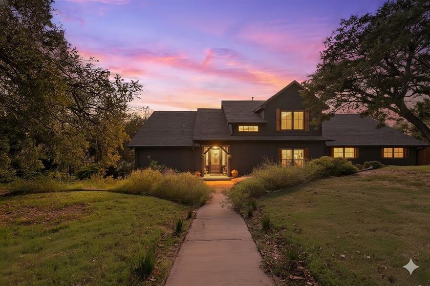 Welcome to your dream waterfront retreat on Lake Granbury! This stunning 3-bed, 2.5-bath home offers the perfect blend of modern upgrades, natural beauty, & peaceful privacy. Nestled on over an acre & surrounded by more than 65 mature cedar trees, the property has the feel of a secluded mountain lodge situated on the water’s edge. 

Inside, the home features 2 spacious living areas & a cozy wood-burning stove, ideal for quiet evenings in. Granite countertops run throughout the home with upgraded KitchenAid black stainless-steel appliances in 2023. Beautiful knotty pine stairs lead to the upper level, where you’ll find pine flooring & a private terrace—perfect for soaking in spectacular lake views. 

The exterior showcases a striking black modern finish with cedar accents, blending contemporary design with rustic charm. The massive covered deck extends across the entire back of the home overlooking low maintenance landscaping that feel like a private oasis. 

This waterfront haven features a double spiral staircase that leads down to a recreational paradise. Enjoy 3 concrete boat slips, 2 of which are covered, convenient kayak storage, & multiple spots to relax right by the lake. The fully heated, cooled, & insulated 16'x24' workshop, 2-car garage with upgraded modern doors, & additional covered parking offer plenty of room for all your lake toys. 

Recent updates include a Class 4 roof added in 2020, a 4.5-ton AC unit in 2022, a fully decked attic running the entire length of the house, & a 12-zone irrigation system can pull from the lake! Community residents enjoy access to tennis courts, pickleball courts, a picnic area, a pool, & a private boat ramp. Perfectly situated on a lake that never runs dry, this one-of-a-kind property is ideal as a full-time residence, weekend getaway, or high-performing investment with short-term rentals permitted. Schedule your private showing today & experience Lake Granbury living at its best!