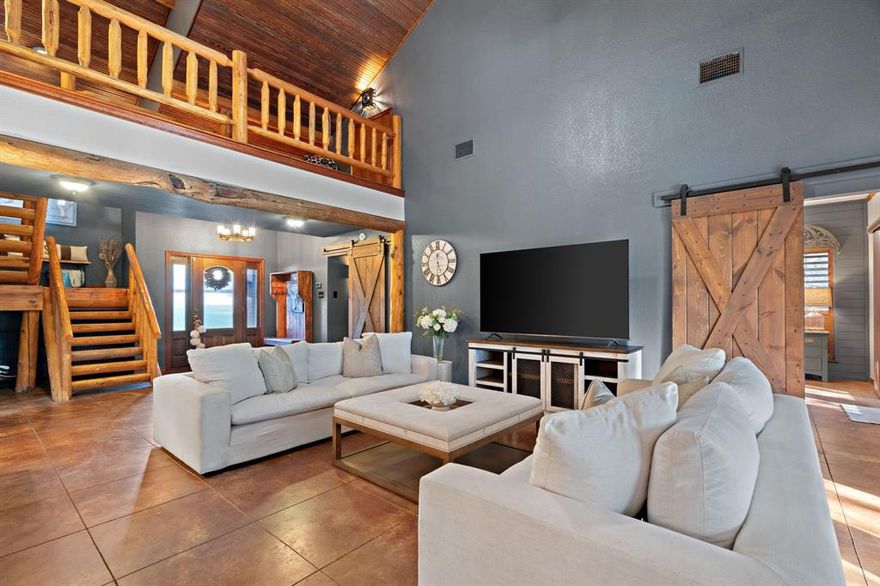 Welcome to your dream waterfront retreat on Lake Granbury! This stunning 4-bed, 2.5-bath home offers the perfect blend of modern upgrades, natural beauty, & peaceful privacy. Nestled on over an acre & surrounded by more than 65 mature cedar trees, the property has the feel of a secluded mountain lodge situated on the water’s edge. 

Inside, the home features 2 spacious living areas & a cozy wood-burning stove, ideal for quiet evenings in. Granite countertops run throughout the home with upgraded KitchenAid black stainless-steel appliances in 2023. Beautiful knotty pine stairs lead to the upper level, where you’ll find pine flooring & a private terrace—perfect for soaking in spectacular lake views. 

The exterior showcases a striking black modern finish with cedar accents, blending contemporary design with rustic charm. The massive covered deck extends across the entire back of the home overlooking low maintenance landscaping that feel like a private oasis. 

This waterfront haven features a double spiral staircase that leads down to a recreational paradise. Enjoy 3 concrete boat slips, 2 of which are covered, convenient kayak storage, & multiple spots to relax right by the lake. The fully heated, cooled, & insulated 16'x24' workshop, 2-car garage with upgraded modern doors, & additional covered parking offer plenty of room for all your lake toys. 

Recent updates include a Class 4 roof added in 2020, a 4.5-ton AC unit in 2022, a fully decked attic running the entire length of the house, & a 12-zone irrigation system can pull from the lake! Community residents enjoy access to tennis courts, pickleball courts, a picnic area, a pool, & a private boat ramp. Perfectly situated on a lake that never runs dry, this one-of-a-kind property is ideal as a full-time residence, weekend getaway, or high-performing investment with short-term rentals permitted. Schedule your private showing today & experience Lake Granbury living at its best!