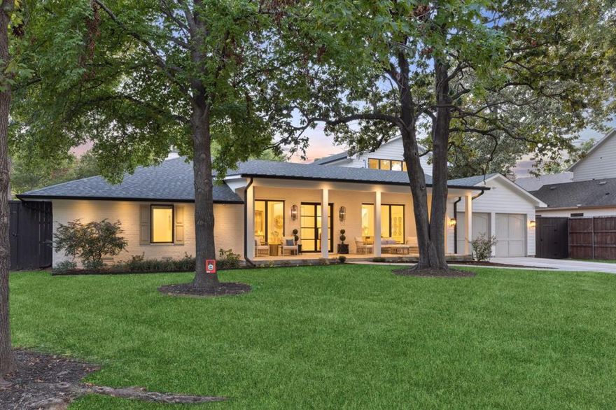 Completely reimagined in 2022, this Forest Hills retreat sits on a rare .4-acre lot just minutes from White Rock Lake and the Dallas Arboretum. With most living space, including the primary suite on the first floor, this beautifully remodeled home offers modern comfort, exceptional privacy, and a setting increasingly hard to find in East Dallas. The home features 5 bedrooms and 3.5 baths with a floor plan that largely lives like a single story. The primary suite, guest suite, game room, and main living areas are all located on the first floor, creating comfortable everyday living. The renovation included new plumbing, electrical, roof, framing, flooring, appliances, and designer finishes throughout, delivering the feel of modern construction while maintaining the charm of Forest Hills. The open kitchen is designed for entertaining with a large marble island, commercial-grade range, Serena & Lily lighting, butler’s pantry, walk-in pantry, and spacious breakfast area that flows into the family room. Upstairs are two additional bedrooms connected by a Jack-and-Jill bath plus a landing ideal for a study or homework space. Outside, the expansive backyard offers ample room for a future pool while maintaining generous green space. Covered front and rear porches overlook mature trees, creating a peaceful retreat tucked within the neighborhood. Surrounded by winding streets and towering trees, Forest Hills remains one of East Dallas’ most beloved communities, with convenient access to White Rock Lake, the Dallas Arboretum, Lakewood dining and shopping, and Downtown Dallas.