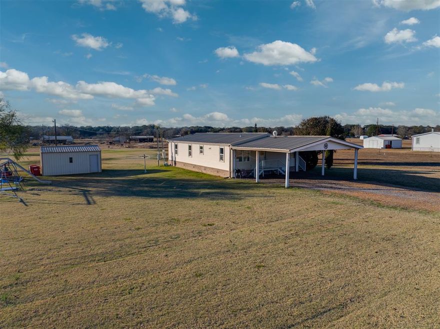 Move-in ready manufactured home with a large attached carport and shed on 1.5 acres in Chisum ISD at a great price. It’s on a private concrete road and about 30 minutes from Paris, Bonham, and Bois d’Arc Lake. Within 10 minutes, you’ll find several manufacturing plants that provide more than 2,000 blue- and white-collar jobs.

The home has a split layout with a large primary ensuite that includes a big soaker tub and a tiled walk-in shower. There are two dining areas plus a kitchen bar, and the kitchen has a cute coffee bar setup. The other two bedrooms and main bathroom are on the opposite side of the home. A patio on the north side gives you shade in the summer, and the well-kept Bermuda grass lawn across the full 1.5 acres gives you plenty of space for outdoor play, gardening, or animals.

With only $10,000 down, payments could be under $1,500 per month.
