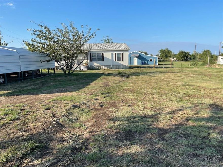 Welcome to an exceptional opportunity to own a spacious inviting home with acreage that is completely fenced and nestled in highly desirable and fast growing Justin, TX. This charming residence boasts 3 generously-sized bedrooms and two well-appointed bathrooms, offering ample space for a growing family or those who love to entertain. Spanning 1,232 well used square feet, this home entails upgrades such as: metal roof 2022, metal skirting 2018, 2 metal car ports 2019, heat pump mini split HVAC system 2024, laminate flooring throughout the house 2024, new stove, washer, dryer 2025. Plus, a 1600 sq ft metal barn with sewage and water connections 2020. The heart of the home features a welcoming living area designed for relaxation and gatherings. The kitchen is equipped to handle your culinary adventures and seamlessly connects to the dining space, perfect for hosting dinner parties or casual meals. The bedrooms offer privacy and tranquility in a park like setting, ensuring restful nights for everyone in the household. Stepping outside, you'll find yourself embraced by the community's serene ambiance, making it a pleasant retreat from the hustle and bustle of everyday life. The 1600 sq ft barn is on concrete slab foundation that offers plenty of space for building a barndominium, raising animals, storage, and other objectives. Located within close proximity to essential amenities, schools, churches and parks, this property is positioned ideally for convenience without sacrificing a country like atmosphere. Don't miss the chance to make this property your own while it's still available.