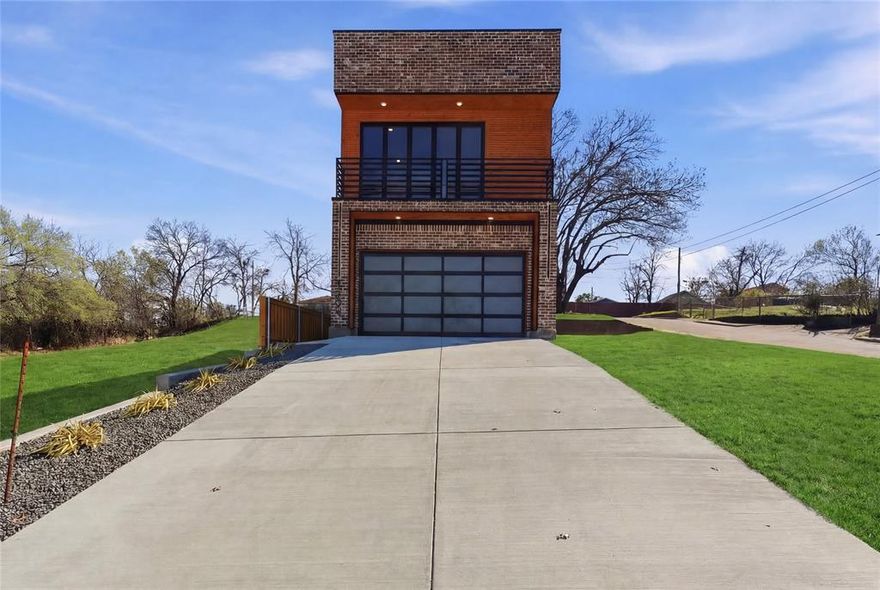 Welcome to modern living at 1402 Hutchins Ave a beautifully designed new construction home offering 2,267 square feet of thoughtfully crafted space in the heart of the city. This stunning residence features 4 spacious bedrooms, including two luxurious primary suites and 3.5 bathrooms, providing flexible living options ideal for families or guests. Inside, you’ll find a sleek contemporary interior highlighted by European-style cabinetry, LED under counter lighting, and a stylish electric fireplace that creates a warm focal point in the main living area. The kitchen is equipped with a premium GE Café appliance package, including a refrigerator, electric range, dishwasher, and microwave perfect for both everyday living and entertaining. Designed with both comfort and efficiency in mind, the home includes a Carrier heat pump system and fully encapsulated foam insulation for superior energy performance. Large 12 x 8 accordion-style doors create a seamless indoor-outdoor flow, bringing natural light and openness into the living space. Architectural highlights continue outside with a TPO roof and a Westcoat rooftop system, providing an excellent moisture barrier and long-lasting structural durability on both the rooftop deck and front balcony ideal for relaxing with city views. The striking 36 x 8 Pella entry door and frosted glass garage door enhance the home’s modern curb appeal. The property is fully enclosed with a board-on-board stained fence and features a private entry gate with keypad access for added privacy and security. A professionally installed alarm system included with monitoring, prepaid for the year and transferable to the new owner. Combining contemporary design, high-end finishes, and thoughtful features, this exceptional Dallas home offers modern comfort and style in a prime location.