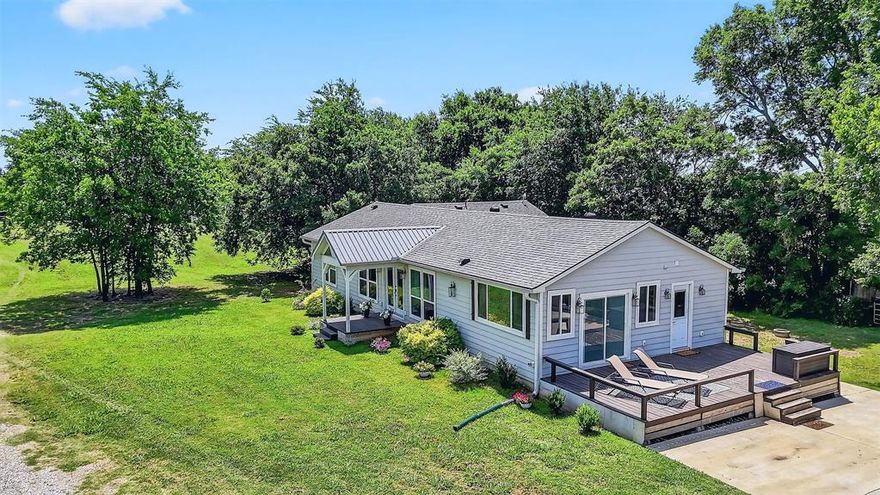 Welcome to this one of a kind country paradise! Just outside city limits but minutes away from Sherman Town Center, Downtown Denison and TMC! This charming home is nestled on 1.82 peaceful acres surrounded by established mature trees and lush greenery as well as plenty of open space that offers endless possibilities. The long, private driveway leads you through mature trees and open skies, arriving at a home that feels tucked away, yet conveniently located.  This spacious property offers the perfect blend of rural charm and suburban connectivity. 
It has been COMPLETELY renovated and expanded to a  4-bedroom, 2-bathroom home in 2021. It balances its timeless beauty with modern-day comfort. Step inside to find warm natural light filtering through large windows, illuminating a space where every detail has been designed. The heart of the home features a beautifully customized kitchen with high-end finishes, including Quartz counter tops, custom cabinets, and large windows that offer the most peaceful serene views. These features flow throughout the entire house! The primary suite is a private retreat with peaceful views flowing seamlessly into the luxurious inspired bathroom.
Whether you're sipping coffee on the large back porch, cultivating a garden, having fun on the zip-line or watching the sunset stretch across open skies, this property offers the perfect blend of comfort, space, and scenic surroundings.