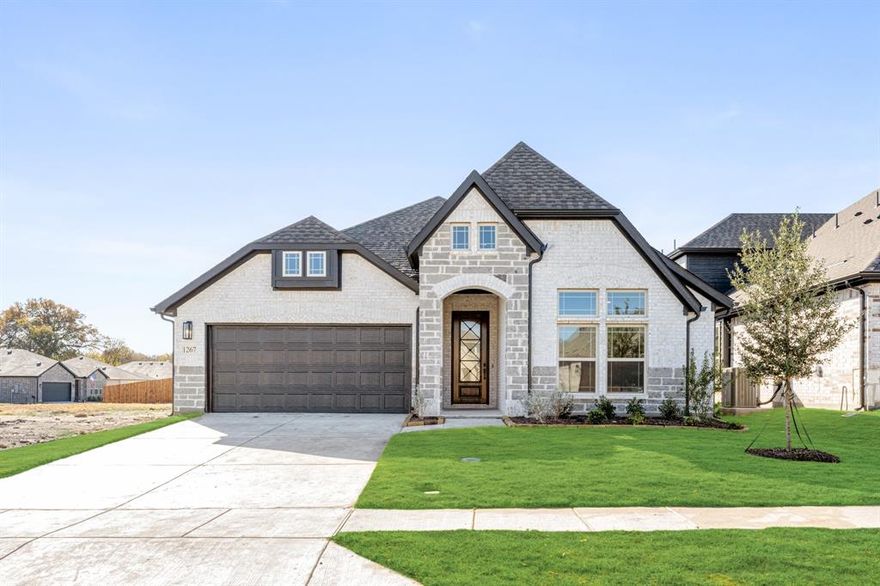 Welcome to the Jasmine by Bloomfield Homes—a thoughtfully designed one-story floor plan that’s cozy, functional, and ideal for a growing family. This 4 bedroom, 3 full bath home is located on an interior lot in the welcoming Anderson Crossing community and features a classic brick exterior with a covered front porch and 8-foot entry door that sets the tone for what’s inside. Step into an open-concept layout where the Deluxe Kitchen takes center stage, showcasing elegant two-tone cabinetry, quartz countertops, under-cabinet lighting, and stylish pendant lights that add a designer touch. The Kitchen flows seamlessly into the Family Room and Breakfast Area, all finished in beautiful laminate wood flooring for easy maintenance and a warm look. The Primary Suite and secondary bedrooms are thoughtfully spaced for privacy and comfort, while the 2-car deep garage provides extra storage space and functionality for busy households. A covered back patio and gutters complete the exterior, offering a great outdoor space to relax or entertain. Located in Anderson Crossing, where residents enjoy a community playground and peaceful surroundings, this home offers everything you need for comfortable living in a welcoming neighborhood. Come see why this Jasmine feels like home the moment you walk in!