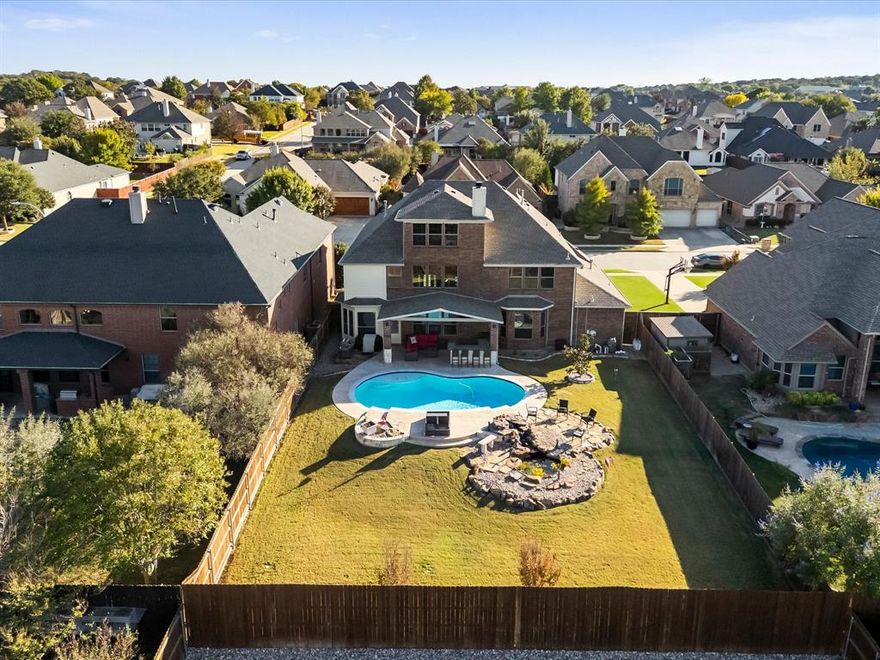 Welcome to luxury living in highly sought-after Keller ISD, where top-rated schools and community charm meet timeless design in this rare, move-in ready three-story brick and stone home with a coveted three-car garage—perfectly blending elegance, space, and modern functionality for multi-generational living, remote work, and upscale entertaining; from the moment you enter, you’re greeted by a light-filled open-concept floor plan with soaring ceilings and designer finishes, anchored by a chef’s gourmet kitchen featuring a large island, granite countertops, stainless steel appliances, custom cabinetry, walk-in pantry, and bright bay windows that flow seamlessly into a spacious family room designed for connection and comfort; upstairs, a versatile game room with a charming Juliet balcony offers flexible living space, while the third-floor bonus room with a wet bar creates the perfect media room, guest suite, home office, or private retreat; the luxurious primary suite provides a serene escape with a spa-like bathroom, dual vanities, soaking tub, separate shower, and an expansive dual-entry walk-in closet; step outside to your own private backyard oasis complete with a sparkling pool, covered patio, built-in outdoor kitchen, lush professional landscaping, sprinkler system, and tranquil koi pond—ideal for year-round enjoyment; all ideally located near parks, walking trails, shopping, dining, and major highways, offering the perfect combination of location, lifestyle, and luxury—schedule your private tour today.