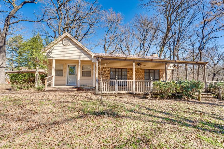 Welcome to 180 Rains County Road 1250, a private East Texas retreat nestled among mature trees with the perfect blend of country charm and functional space. If you’ve been dreaming of peaceful acreage living with room for all your toys, hobbies, and lake adventures, this is it.
The home itself could use a little TLC, but still offers warm character with vaulted ceilings, exposed beams, and a spacious kitchen featuring abundant cabinetry and counter space. The open living areas provide plenty of room to gather, while large windows invite in natural light and serene wooded views. Outside, enjoy covered porches perfect for relaxing mornings or unwinding evenings under the trees. Build your Homestead here. Bring your horses or your bees! 

The true standout feature? The large metal building complete with RV hookups, making it ideal for lake goers, travelers, hobbyists, or anyone needing serious storage and workspace. Whether you have boats, ATVs, equipment, or an RV, this property is built to accommodate it all. Bring your horses, bees and homestead. 

Located just minutes from some of East Texas’ most sought-after lakes, including Lake Fork and Lake Tawakoni, you’ll enjoy world-class fishing, boating, and year round recreation practically at your doorstep. Spend your days on the water and your evenings back at your own private retreat. With expansive concrete drive space, additional covered areas, and multiple outbuildings, this property offers flexibility for full time living, a weekend lake getaway, or even a short term rental opportunity. Two Tax IDs included in this listing. one is R2356 which is 5.341 acres and the other smaller lot is R32723 and is 1.581 for a total of 6.922 acres!

Country living. Lake proximity. Shop space. RV ready.
This is East Texas living done right. Won't last long, come see it today!

Currently no Real Estate sign on Property. Contact BrokerBay to schedule a showing 1.800.257.1242