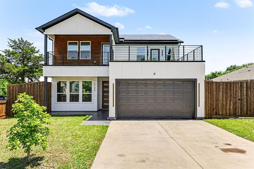 Endless great times will be had in this striking, energy-efficient modern home situated in the heart of Dallas. Built in 2023 and upgraded with solar panels, this 4-bedroom, 2.5-bathroom residence opens to a bright dedicated office or sunlit sitting area on the left. The entry flows seamlessly into a spacious living room centered around a decorative fireplace and framed by large windows. Designed for entertaining, the open-concept chef’s kitchen boasts a massive island with ample seating and overlooks the expansive dining area. Accent walls and abundant windows anchor the main floor, offering panoramic views of the massive backyard. Step outside to a covered patio perfect for outdoor dining. The sprawling yard is a blank canvas ready for a pool or sports court. Upstairs, you will find four bedrooms, including a luxurious primary suite featuring an accent wall, a second decorative fireplace, a spa-like ensuite shower, and a walk-in closet. Slide open the private door to your personal, partially covered balcony—complete with artificial turf—ideal for hosting guests or relaxing in style while enjoying lower utility costs.