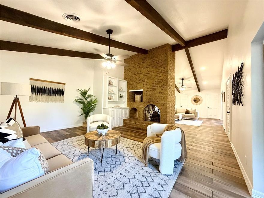 0.2 mi to Historic Pilot Point Square • 2.5 mi to Lake Ray Roberts & Lone Star Lodge • Sunroom + pool + large lot

Updated home on a 0.57-acre lot close to downtown Pilot Point and minutes from lake recreation. This property blends the character of its 1978 architecture with a full interior refresh. The main living room features exposed wood beams, wide windows, and a floor-to-ceiling brick wall with a double-sided fireplace that opens to a connected seating area. Large glass sliders bring in natural light and lead directly to the backyard and pool.

The kitchen includes granite counters, a gas cooktop, double ovens, stainless appliances, white cabinetry, and a stained-glass arched pass-through window that adds a unique focal point. An open dining area connects to the living space for easy flow. A separate sunroom adds flexible space for lounging or hobbies. Updated wood-look tile runs throughout the home for durability and a consistent look.

The primary suite is oversized with direct pool access through large sliders. The remodeled bath features a spacious walk-in shower, dual vanities, arched niches, updated lighting, and built-in shelving. Secondary bedrooms sit away from the main living areas for added privacy, and the updated second bath serves the guest rooms and hallway.

Outside, the property includes a resort-style pool with a large deck, fenced yard, and open side yards. The circular driveway and side-entry garage offer convenient access and extra parking. The lot provides privacy and plenty of outdoor space.

The home sits two blocks from the historic town square with local retail, dining, and community activity. Lake Ray Roberts is about 2.5 miles away and offers boating, fishing, trails, and dining at Lone Star Lodge & Marina. Nearby roadway access connects Pilot Point to surrounding Denton County areas.