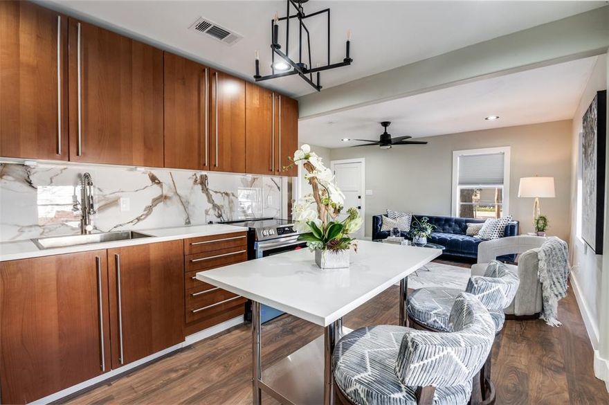 Welcome to 826 W. Laramie Lane, a beautifully renovated, open-concept home less than 15 minutes from downtown Dallas! The home blends modern style with cozy cottage charm and features all-new electrical, plumbing, insulation, HVAC, roof, and water heater—giving buyers peace of mind for years to come. The kitchen shines with white granite backsplash, a stainless steel island, and brand-new Frigidaire appliances. Luxury waterproof flooring runs throughout the home, with original hardwoods underneath as the option for future homeowners to refinish the hardwood floors to their original charm is still there!  Enjoy a spa-like bath with a cast-iron tub and decorative tile, plus charming barn doors and energy-efficient foam insulation. Outside, find a spacious backyard with St. Augustine sod, light landscaping, and a 180-sq-ft storage shed that has the potential for electric and plumbing to be restored, if desired. With over 10,000 square feet of land there is the opportunity to add on to the square footage of the home while still having a decent sized yard. The property will be sold as is. Schedule a tour today!