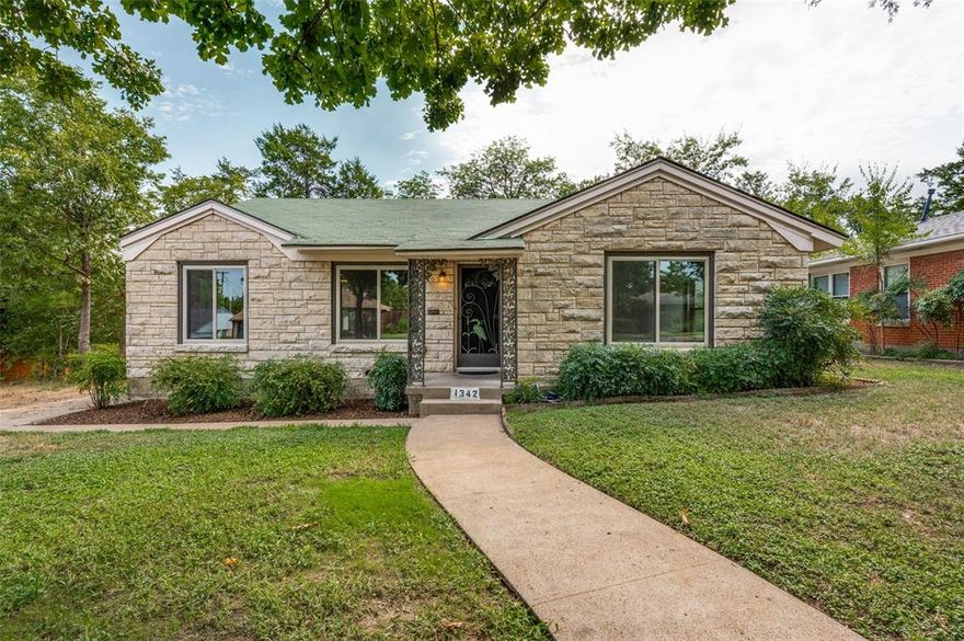 Vintage Austin Stone Bungalow circa 1948 opened up and reimagined, while retaining its original charm and magic.  This is the one; from the moment you enter this delightful home you will notice the difference in both quality of finish out, as well as attention to detail. This three-bedroom two full bath home offers big home amenities in a small package. The kitchen has been opened to the dining room just enough to create an open space without compromising the integrity of the original design but making it more functional and inviting. Kitchen upgrades included electrical, plumbing, fixtures, appliances, new cabinets and counters, as well as creating a great little utility laundry space and mud room. Additional upgrades include ensuite master bath, as well as tankless hot water, and two completely updated and vintage looking bathrooms. Additional amenities include oversized detached two car garage, just five minutes to the Dallas Zoo and the new Halperin deck park, as well as a short drive to downtown Dallas and the Bishop Arts district!