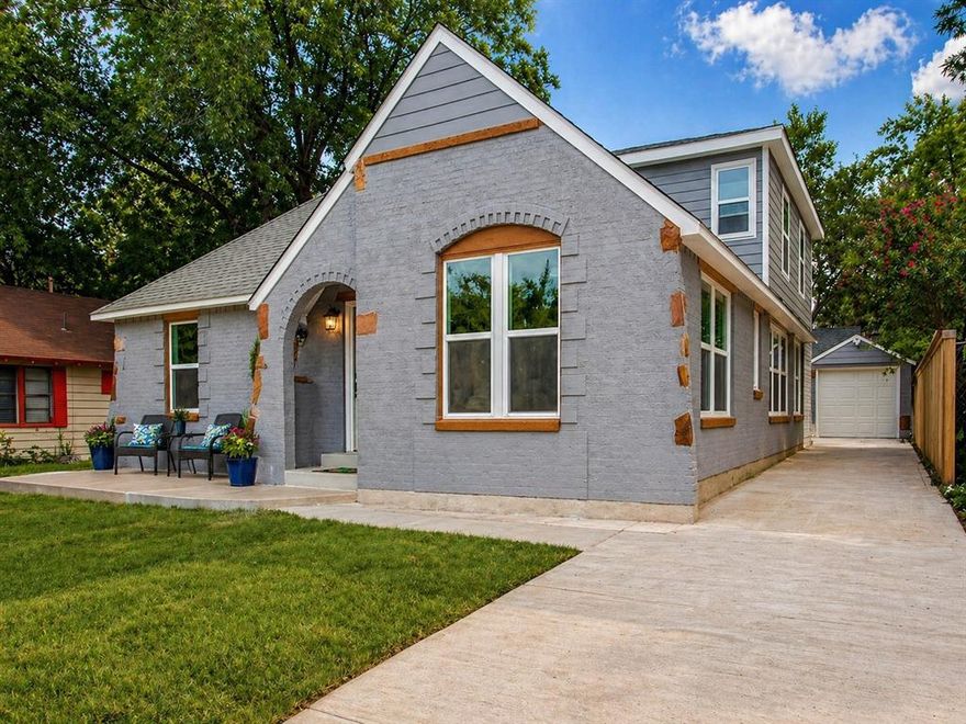 Nestled in the established Sunset Hill neighborhood in the heart of North Oak Cliff, just minutes from the vibrant Bishop Arts District and scenic Kidd Springs Park, this beautifully reimagined 1916 Tudor Revival cottage blends timeless craftsmanship with modern sophistication. From the moment you enter, you’re greeted by rich wood flooring spanning much of the main level, complemented by fresh interior paint, plantation shutters, and energy-efficient windows. Upstairs, brand-new carpeting adds comfort and style. The expansive living and dining areas flow seamlessly together, offering flexibility to design the space around your lifestyle. The chef’s kitchen is both elegant and functional, featuring granite countertops, stainless steel appliances, a gas cooktop, glass mosaic backsplash, and abundant white shaker cabinetry. An oversized buffet-style serving area enhances both everyday living and entertaining. Nearby, the breakfast nook offers versatility as a casual dining space or convenient drop zone. A private study just off the foyer provides the perfect flex space, ideal as a home office, gym, secondary living area, or whatever suits your needs. The main-level owner’s retreat is a true sanctuary, complete with a spa-inspired bath showcasing a large walk-in shower with pebble flooring and full tile surround, dual vanities with granite counters, and a spacious walk-in closet. Upstairs, enjoy a generously sized game and media room with ample space for a pool table and home theater setup, along with two additional bedrooms and a full bath. Step outside to your own backyard oasis—an entertainer’s dream. The sparkling PebbleTec pool, raised stacked-stone spa, and dramatic fire bowls create a resort-like ambiance. The covered outdoor kitchen with travertine flooring, gas connections, wet bar, and prep area makes hosting effortless year-round. This is where historic charm meets modern living—welcome home.