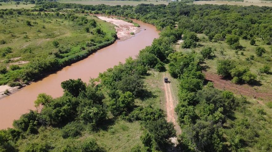 JYN RANCH – 250 Acres of Scenic Beauty & Functionality. Welcome to your private 250 acre retreat with approximately 1.6 miles of Brazos River frontage. This exceptional property offers a perfect balance of recreation, ranching, and comfortable living two hours from DFW metroplex and 30 minutes from Graham for a quick trip for dinner.  Situated on the ranch is a fantastic 4,000 sq.ft. barndominium featuring 1,687 sq.ft. of beautifully finished living space.  With 3 bedrooms, 2 full bathrooms, stained concrete floors, and a warm rustic interior, it’s ideal for full-time living or weekend escapes. The open-concept layout centers around a well-appointed kitchen, perfect for entertaining and opens to a spacious wrap-around porch, offering peaceful views and outdoor relaxation. Attached is a 2,313 sq.ft. insulated shop with 5 overhead doors, one with electric opener, providing ample space for equipment, storage, and projects. Living space, shop, wrap around porch and shed under roof is 6,500 s.f.  An EF-5 rated storm shelter located in the shop. The ranch is fully serviced with co-op water and electricity, with two water meters and one electric meter.  On the ranch is also a well-maintained 3 bed, 2 bath double-wide that offers comfortable accommodations for guests or extended family. It features a covered porch and a cozy fire pit area, perfect for gatherings under the stars. The land is fully fenced and cross-fenced, with pens and chutes for livestock. Approximately 65 acres of cultivated ground are being converted to improved grasses, enhancing its agricultural value. The balance of the property is heavily wooded with mature oaks, two stock tanks, and sandy loam soil, creating a haven for wildlife, hunting, and fishing. Capability of creating a waterfowl detention area for hunting with the tanks.   This is more than a property—IT'S A LIFESTYLE.  Whether you're looking for a recreational paradise, a working ranch, or a peaceful riverfront escape, this ranch has it all.