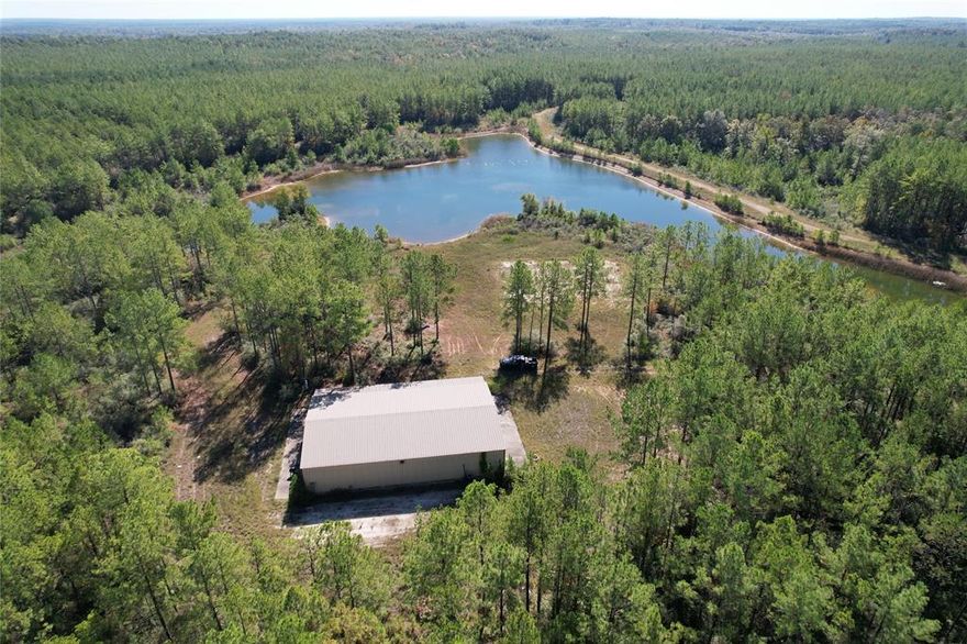 Take a look at all this 600+ acres have to offer. Upon entering the property, you will find a ¾ mile- long, all-weather road. You will then come across a beautiful dam and up to a large metal building on the north side of the small lake. The lake covers about 7+ acres and is beautifully contoured, creating a gorgeous sight from the porch of the metal building. The 50x80 metal building offers a nice, climate-controlled bunk room and finished out bathroom complete with a shower. . The building is serviced with a water well and an aerobic septic system. This property also boasts over 600 acres of timber land. The property has several miles of trails, making it accessible for the nature lover or the recreational enthusiast. There are predominantly pine plantations on site but the creeks running through the property offer hardwood corridors for numerous deer and other wildlife. This property is less than a mile off of the Sabine River.