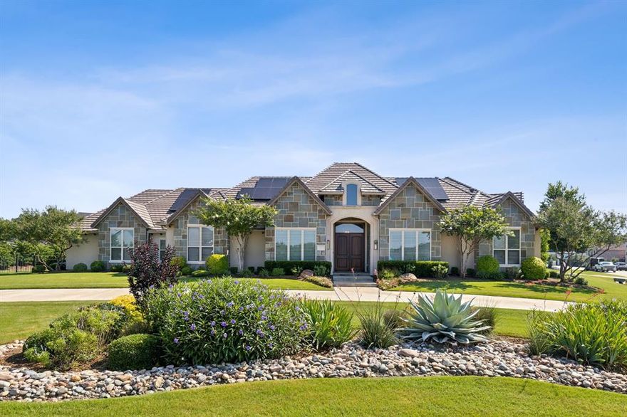 Welcome to 1840 Tranquility Ct! Situated in the prestigious gated community of Christie Farms in Prosper, this stunning single story custom-built 2018 estate by Dave R. Williams spans over 5,783 sq. ft. on an acre-plus corner lot. This luxurious home features 5 spacious bedrooms, each with an ensuite bath, plus an additional half bath for guests and poolside convenience. Upon entry, you'll be greeted by expansive windows, large sliding doors, soaring ceilings, and elegant high-end finishes, including natural hardwood floors and architectural wood beams. The chef’s kitchen is a culinary dream, boasting a 36in Wolf range, Wolf wall and convection ovens, a 60in SubZero refrigerator, natural stone countertops, and custom cabinetry. Enjoy meals in the breakfast nook or formal dining room, perfect for hosting gatherings. The owner's retreat offers a grand bedroom, spa-like bathroom, and a massive walk-in closet. Additional interior spaces include a custom home office, game room, fully equipped media room, and 6 person storm shelter. The property features 4 oversized attached garages and a climate-controlled detached 2-car garage, providing space for six vehicles. The concrete tiled roof is outfitted with solar panels that have the ability to power the entire home. The outdoor living is exceptional with over 1,000sf of covered space, a fully equipped outdoor kitchen, retractable drop down screens, a resort-style heated pool and spa, and ample room for recreation. Located in Prosper ISD, this home is zoned for Cockrell Elementary, Rodgers Middle School, and Walnut Grove High School.