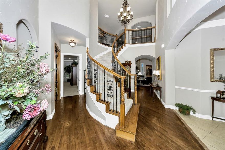 Luxurious home in 24-7 guarded gated home on pristine 18 hole golf course lot in waterfront community. Stunning! New Roof, Exterior painted, plus new AC. Features 4 beds, 4.5 baths, 2 living areas, 2 dining, media & game rms plus spacious study featuring coffer beamed ceiling, plantation shutters. Impressive flex rm with wood floors & plantation shutters. Upscale appliances, Jenn-air & Bosch, ensuring highest culinary standards plus  butlers pantry for chef’s delight while entertaining with ease. Elegant wood floors, archways, art niches, extensive moldings & elegant fixtures create a refined ambiance. Spacious primary suite offers a tranquil retreat overlooking golf course. The versatile room would be the perfect spot for a nursery next to the primary suite. Living area with floor to ceiling brick & stone, gas log fireplace, & electric shades. Upstairs features include media rm with bar sink, next media is half bath & billiard-game rm overlooking spacious covered balcony with scenic views of golf course. Secondary bed with golf course view & private bath. 3rd bed plus bath. 4th bed has been converted to full rm closet & private sitting rm. This unique rm could be workout rm, sewing room playroom or converted back to another bed with walk-in closet. Private patio just outside of living area perfect for private entertaining & enjoying scenic views of the lush golf course surroundings. 2 tankless water heaters to ensure everyone enjoys hot water at all times! Practical mud area & generous laundry rm with sink add convenience to your daily routine. Expansive 3 car gar comfortably accommodates cars & a golf cart, making it a golfer's dream. Experience a lifestyle of sophistication & leisure in this meticulously designed home. Amenities include golf, clubhouse restaurant, bar, 2 pools, fitness area, pickleball, tennis & basketball courts, playground, beach area, boat ramps, boat slips. Zoned for new Eg Mtn High School. Past 11th Tee. $10K Carpet Allow with accepted offer