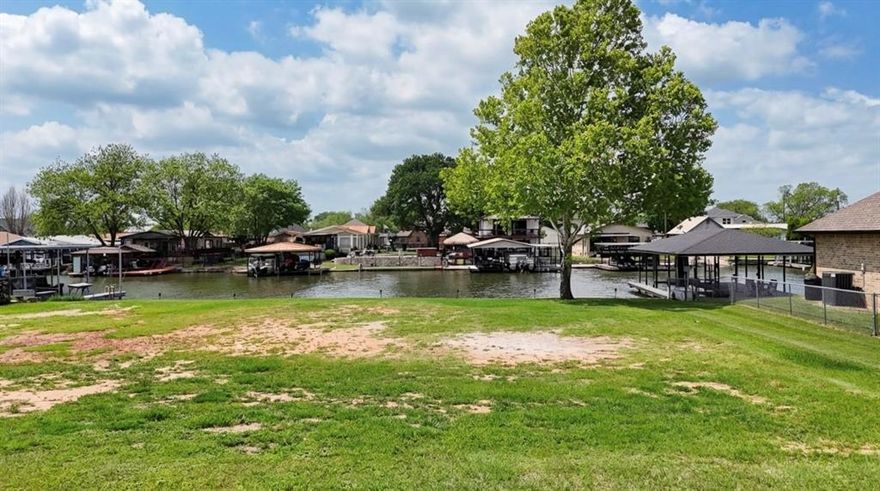 Rare opportunity to own a waterfront lot on one of the largest canals on Lake Granbury! This .148-acre lot offers direct canal frontage with a concrete bulkhead already in place, putting you just a short distance from the main body of the lake. Enjoy stunning open water views, mature shade trees, and the peaceful lifestyle that lakefront living provides. The lot is build-ready with neighboring boat docks and covered slips on either side, giving you a clear vision of the waterfront home you can create. Located in the Comanche Harbor Ports O Call community, residents enjoy access to a community boat ramp, clubhouse, park, playground, and more. Whether you're looking to build your dream lake home or a weekend getaway, this is the canvas you've been waiting for!